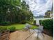 Relaxing patio with table and chairs, surrounded by lush greenery at 663 Pinehurst Dr. # 93C, Pawleys Island, SC 29585