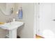 Modern bathroom with pedestal sink and stylish fixtures at 6730 Newcastle Ln., Ocean Isle Beach, NC 28469