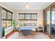 Bright sunroom with window seating and serene water views at 6730 Newcastle Ln., Ocean Isle Beach, NC 28469