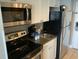 Convenient kitchen boasts stainless steel microwave and stove, ample counter space, and modern appliances at 6900 N Ocean Blvd. # 614, Myrtle Beach, SC 29572