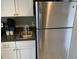 Efficient kitchen features stainless steel refrigerator, sink, and white cabinetry for a clean look at 6900 N Ocean Blvd. # 614, Myrtle Beach, SC 29572