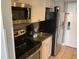 Compact kitchen equipped with stainless steel appliances, granite countertops, and ample cabinet space at 6900 N Ocean Blvd. # 614, Myrtle Beach, SC 29572