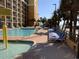 Beautiful pool and lounging area with palm trees and a glimpse of the beach at 6900 N Ocean Blvd. # 614, Myrtle Beach, SC 29572