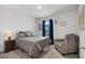 Cozy bedroom with a comfortable bed and a sitting chair at 7015 River Bridge Ct, Myrtle Beach, SC 29579