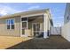 Home exterior showcasing a screened porch and fenced backyard at 9179 Fort Hill Way, Myrtle Beach, SC 29579