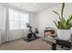 Home office features Peloton bike, desk, and large window at 9179 Fort Hill Way, Myrtle Beach, SC 29579