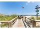 Convenient boardwalk to beach with directional signage at 9560 Shore Dr. # 3A, Myrtle Beach, SC 29572