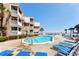 Refreshing pool area with ample lounge chairs for relaxation at 9560 Shore Dr. # 3A, Myrtle Beach, SC 29572