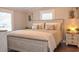 Spacious bedroom with a light-toned wooden bed frame and window shutters at 1005 S Marlin Circle, Murrells Inlet, SC 29576