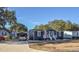 Gray house with white trim, carport, and landscaping at 1005 S Marlin Circle, Murrells Inlet, SC 29576