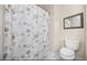 Clean bathroom with shower/tub combo and beach-themed decor at 1023 Marthas Way, North Myrtle Beach, SC 29582