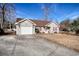 One-story house with attached garage, red shutters, and a spacious yard at 104 Osprey Cove Loop, Myrtle Beach, SC 29588