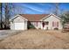 One-story house with attached garage, red accents, and a well-maintained lawn at 104 Osprey Cove Loop, Myrtle Beach, SC 29588