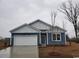 New construction home with blue siding, white trim, and a two-car garage at 1107 Black Lake Way, Conway, SC 29526