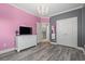 Bright bedroom with pink and gray walls, a white dresser, and double doors at 117 Ashley River Rd., Myrtle Beach, SC 29588