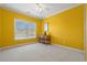 Spacious bedroom with yellow walls, a window with natural light, and hardwood floors at 117 Ashley River Rd., Myrtle Beach, SC 29588