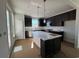 Stylish kitchen featuring black cabinets, a white countertop, and a center island with pendant lighting at 1273 Lady Bird Way, North Myrtle Beach, SC 29582