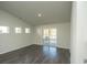 Living room with sliding glass door to patio and hardwood floors at 1574 Jardine Loop, Little River, SC 29566