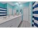 Bathroom with double vanity and teal walls at 1584 Swing Bridge Way, Myrtle Beach, SC 29588