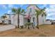 Two-story house with gray siding, palm trees, and a two-car garage at 1584 Swing Bridge Way, Myrtle Beach, SC 29588