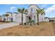 Two-story house with gray siding, palm trees, and a two-car garage at 1584 Swing Bridge Way, Myrtle Beach, SC 29588