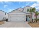 Two-story house with gray siding, palm trees, and a two-car garage at 1584 Swing Bridge Way, Myrtle Beach, SC 29588