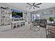 Living Room with gray sectional sofa, large TV, and white shelving at 1584 Swing Bridge Way, Myrtle Beach, SC 29588