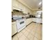 White kitchen with ample cabinetry and tiled floors at 1650 Deercreek Rd., Surfside Beach, SC 29575