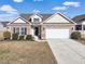 Brick ranch house with attached garage and landscaping at 169 Riverwatch Dr., Conway, SC 29527