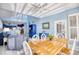 Bright dining area with wooden table and white chairs, kitchen view at 19 Cattail Ct. # 2B, Pawleys Island, SC 29585