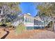 House exterior showcasing a light grey home with a screened porch at 19 Cattail Ct. # 2B, Pawleys Island, SC 29585