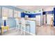 Bright blue kitchen with white appliances and breakfast bar at 19 Cattail Ct. # 2B, Pawleys Island, SC 29585