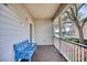 Relaxing front porch with blue bench overlooking a waterway at 19 Cattail Ct. # 2B, Pawleys Island, SC 29585