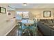 Casual dining area with white table, teal chairs, and ocean view at 1906 S Ocean Blvd. # 108A, Myrtle Beach, SC 29577