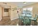 Small dining area with a round table and four teal chairs at 1906 S Ocean Blvd. # 108A, Myrtle Beach, SC 29577