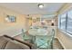 Charming dining area with a round table and four teal chairs at 1906 S Ocean Blvd. # 108A, Myrtle Beach, SC 29577