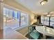 Bright dining area with ocean view, white table, and teal chairs at 1906 S Ocean Blvd. # 108A, Myrtle Beach, SC 29577