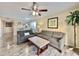 Living room with grey sectional sofa, coffee table, and ceiling fan at 1906 S Ocean Blvd. # 108A, Myrtle Beach, SC 29577