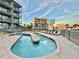 Relaxing kidney-shaped pool with lounge chairs and ocean view at 1906 S Ocean Blvd. # 108A, Myrtle Beach, SC 29577