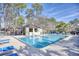 Community pool with lounge chairs and surrounding trees at 204 Pipers Glenn # 204, Myrtle Beach, SC 29575