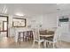 Charming dining area features a round wooden table, white chairs, and is adjacent to the kitchen at 205 56Th Ave. N, North Myrtle Beach, SC 29582