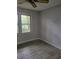 Bright bedroom with grey flooring and large window at 2228 Oyster Cove, Murrells Inlet, SC 29576