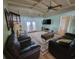 Living room with leather sofas, a coffee table, and access to a sunroom at 2228 Oyster Cove, Murrells Inlet, SC 29576