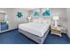 King bedroom with coastal decor and blue carpet at 2801 S Ocean Blvd. # 1131, North Myrtle Beach, SC 29582