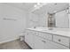 Bathroom features a double vanity with white cabinets, a large mirror, and tile flooring at 2871 Ellesmere Circle, Myrtle Beach, SC 29579