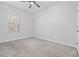 Bright bedroom features neutral carpet, a ceiling fan, and a window bringing in natural light at 2871 Ellesmere Circle, Myrtle Beach, SC 29579