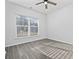 Bedroom with a large window, gray-toned wood flooring, and a ceiling fan at 2871 Ellesmere Circle, Myrtle Beach, SC 29579