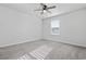 This cozy bedroom includes neutral carpet and a ceiling fan at 2871 Ellesmere Circle, Myrtle Beach, SC 29579