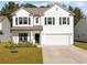 Traditional two story home with white siding, black shutters, covered porch and two car garage at 2871 Ellesmere Circle, Myrtle Beach, SC 29579