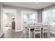 Bright dining area with table and chairs, leading to the kitchen at 289 Bent Green Ct. # 76C, Murrells Inlet, SC 29576